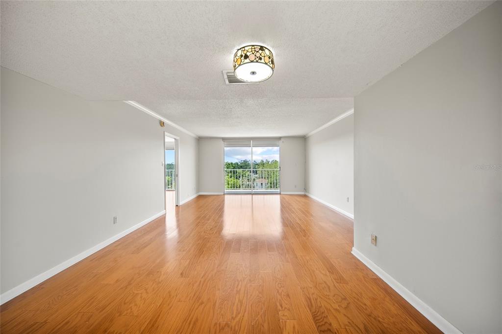 2611 Bayshore Boulevard, Unit 504 Tampa, FL 33629 - Photo 8 of 39 a view of an empty room with window and wooden floor