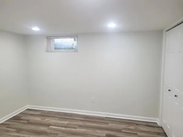 a view of a small space with wooden floor and windows
