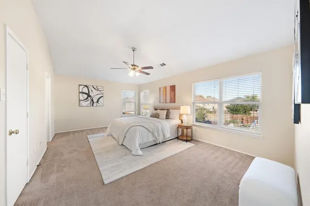 a spacious bedroom with a large bed and a window