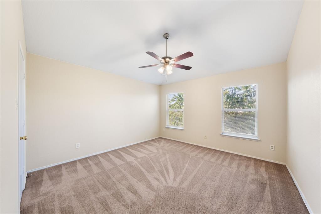 13604 Ponderosa Ranch Road Fort Worth, TX 76262 - Photo 15 of 27 an empty room with windows and fan