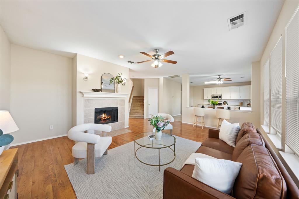 13604 Ponderosa Ranch Road Fort Worth, TX 76262 - Photo 2 of 27 a living room with furniture and a fireplace