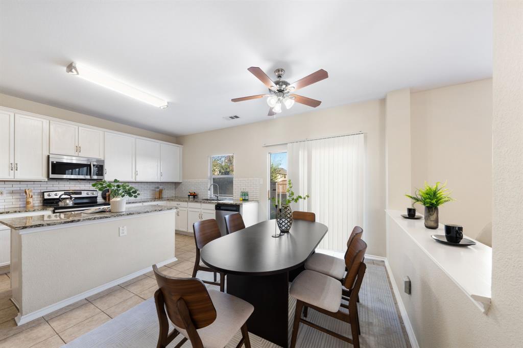 13604 Ponderosa Ranch Road Fort Worth, TX 76262 - Photo 24 of 27 a view of a dining room with furniture and a kitchen