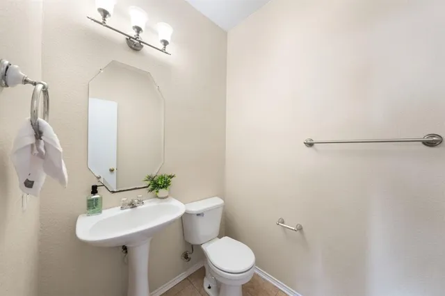 a bathroom with a sink toilet and mirror