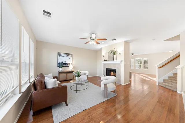 a living room with fireplace furniture and a wooden floor