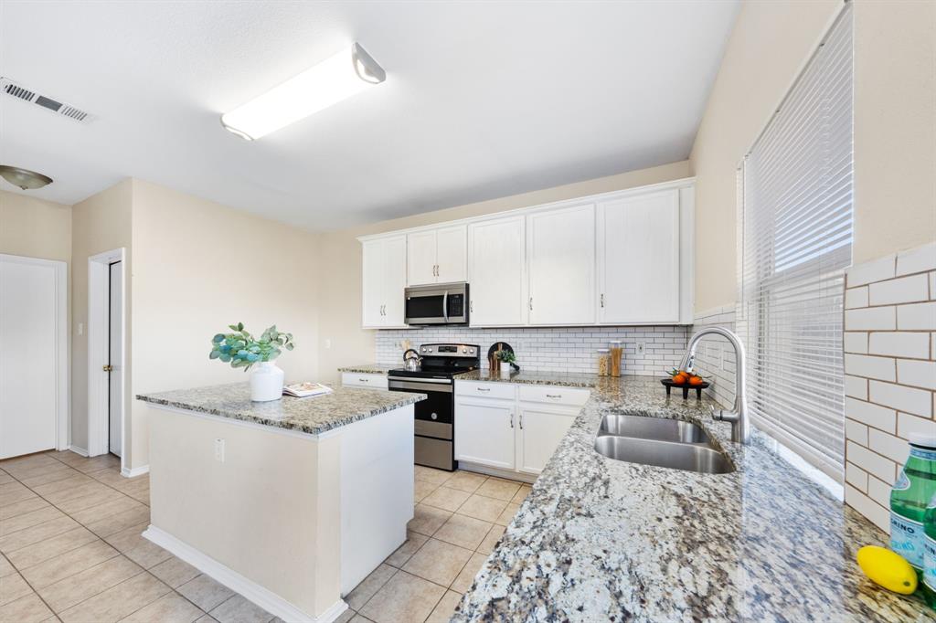 13604 Ponderosa Ranch Road Fort Worth, TX 76262 - Photo 5 of 27 a kitchen with a sink stove and cabinets