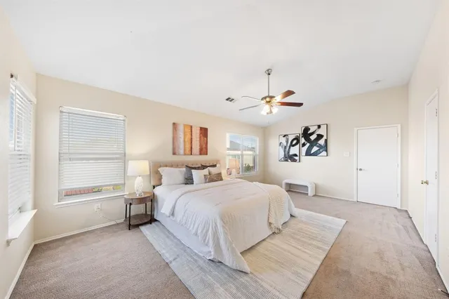 a bedroom with a large bed and a chandelier