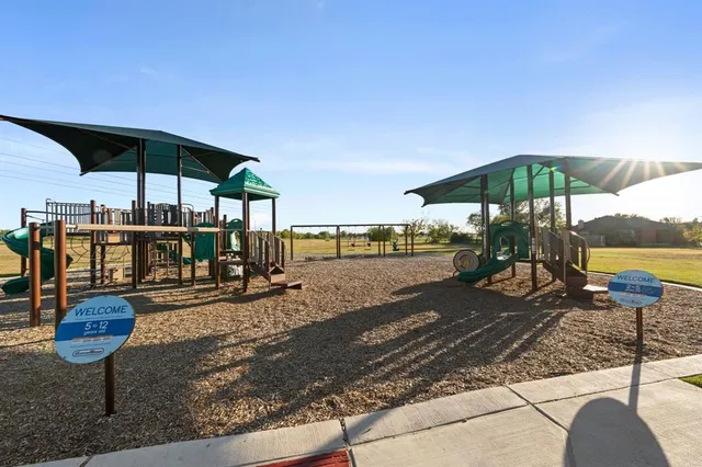 a view of a table and chairs under an umbrella