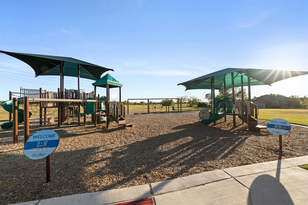 13604 Ponderosa Ranch Road Fort Worth, TX 76262 - Photo 10 of 27 a view of a table and chairs under an umbrella