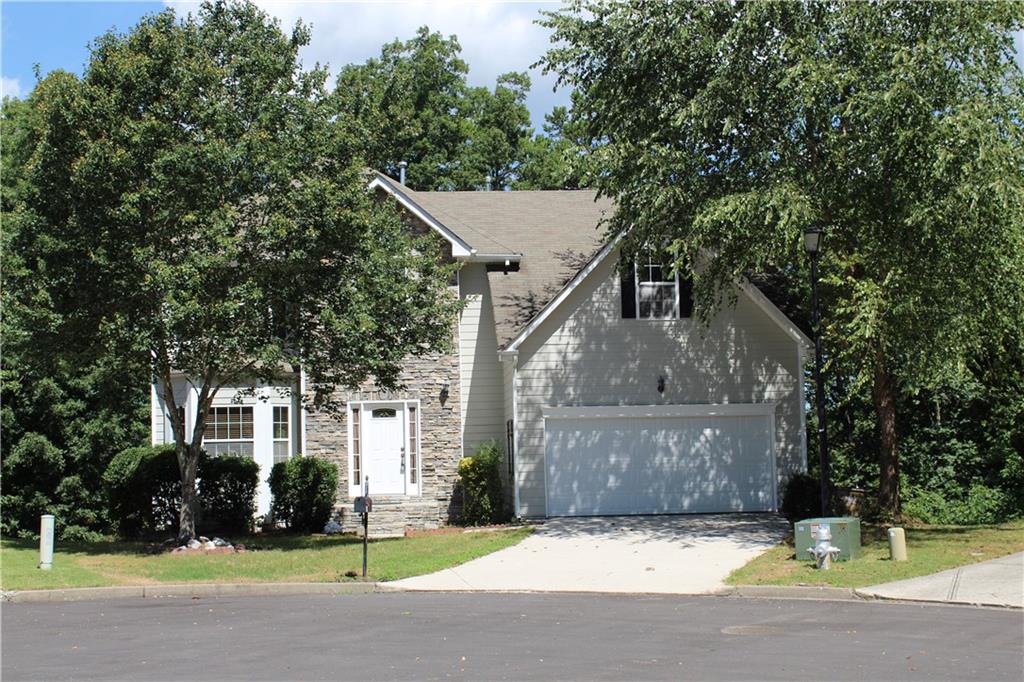 965 Tree Top Drive Suwanee, GA 30024 - Photo 1 of 1 a front view of a house with a yard and garage
