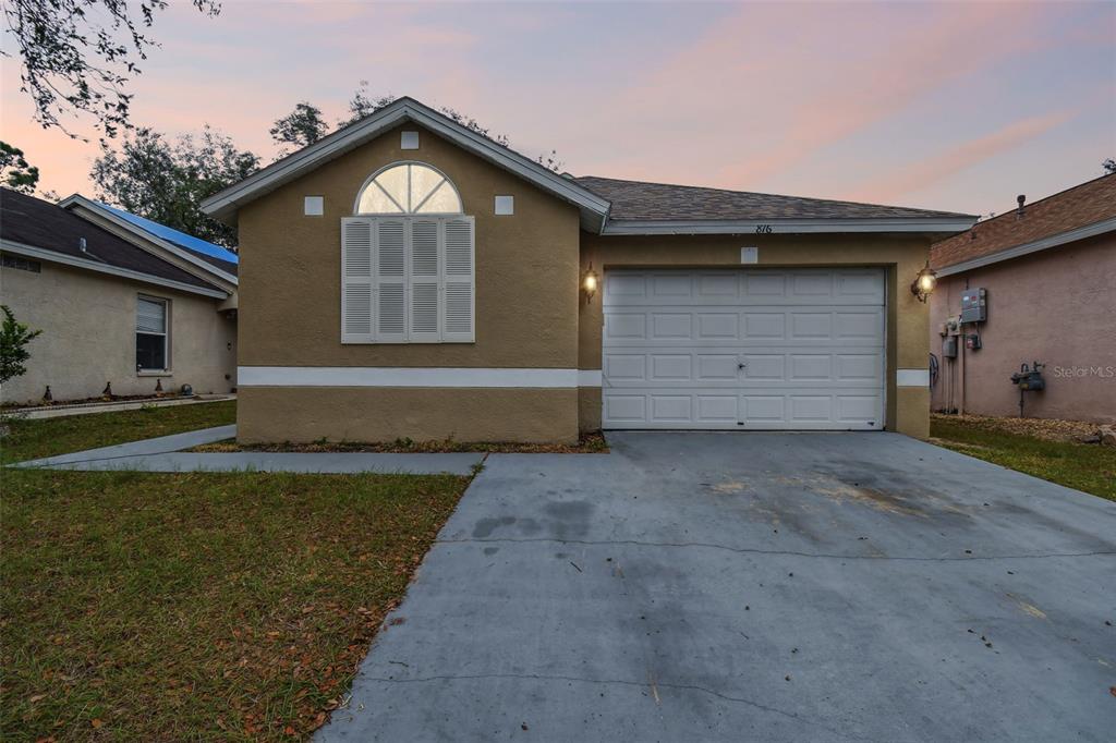 816 Cape Cod Circle Valrico, FL 33594 - Photo 1 of 1 a front view of a house with a yard and garage