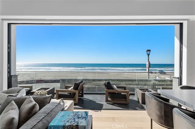 a kitchen with a stove a sink dishwasher a dining table and chairs with wooden floor