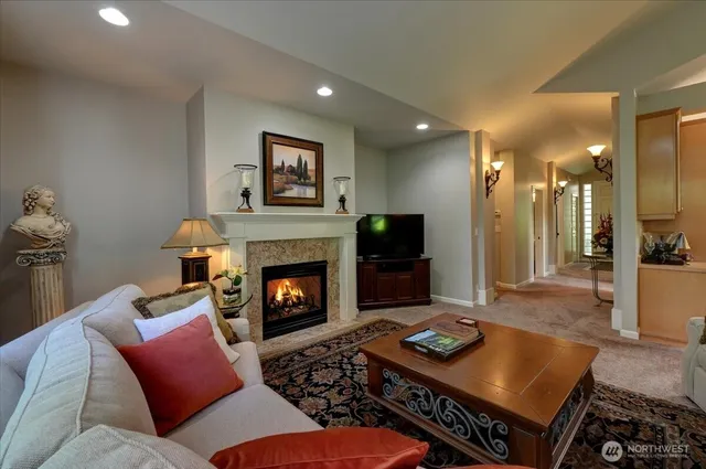 a living room with furniture a flat screen tv and a fireplace
