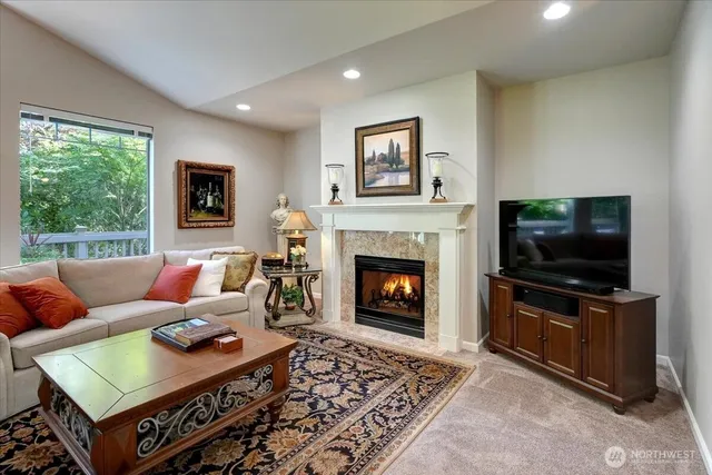 a living room with furniture large window and a fireplace