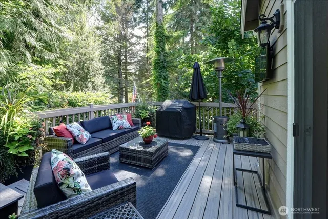 a outdoor sitting area with furniture and wooden floor