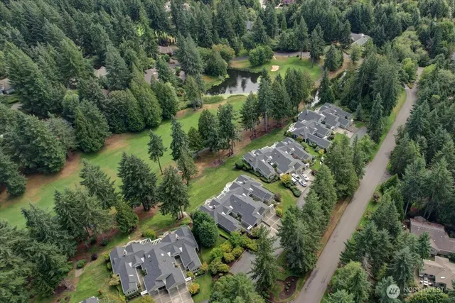 an aerial view of a house with a yard and trees