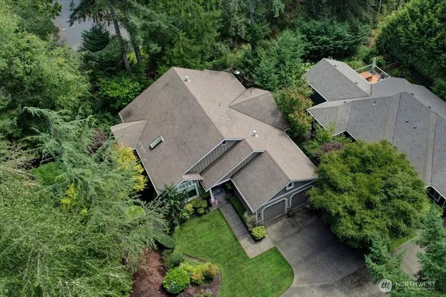 a view of a house with a yard and potted plants
