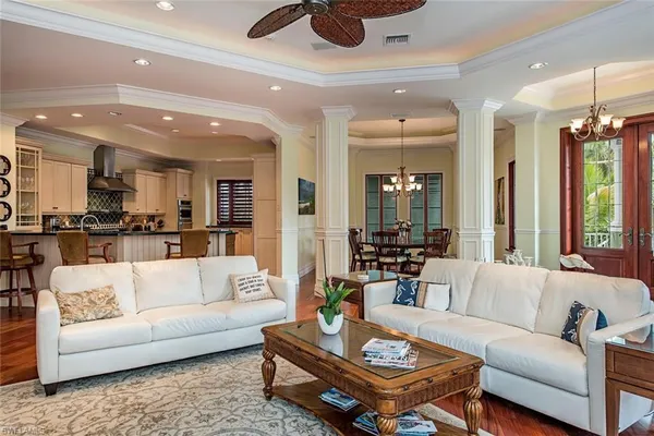 a living room with furniture and kitchen view