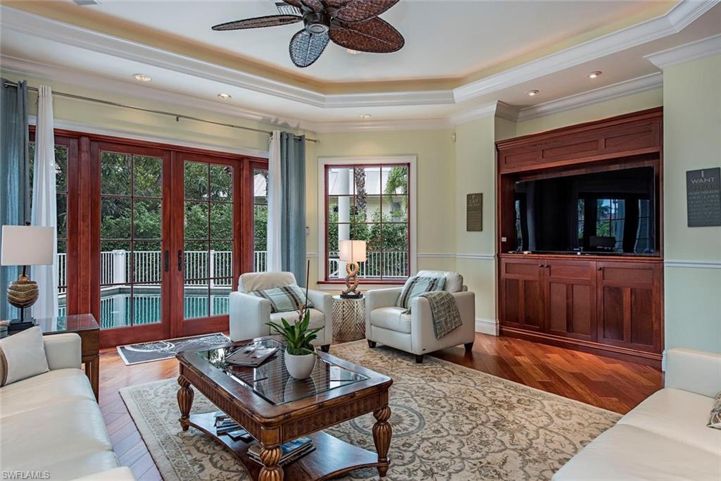 85 13th Avenue South Naples, FL 34102 - Photo 4 of 13 a living room with furniture and a flat screen tv