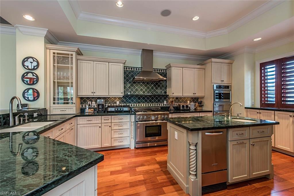85 13th Avenue South Naples, FL 34102 - Photo 5 of 13 a kitchen with stainless steel appliances granite countertop a sink stove and cabinets
