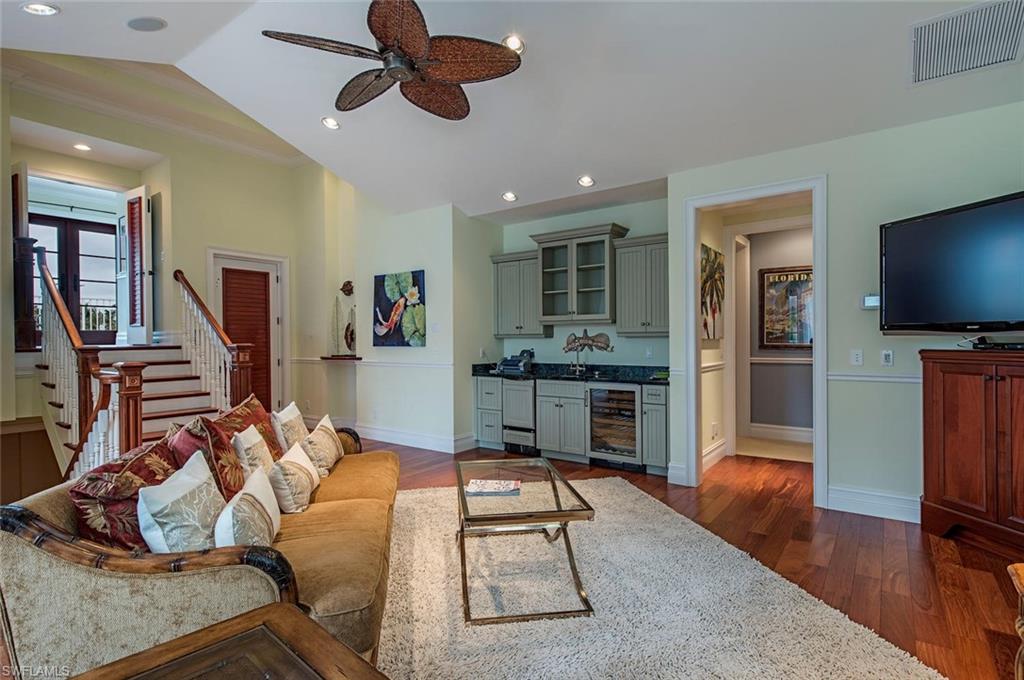 85 13th Avenue South Naples, FL 34102 - Photo 6 of 13 a living room with furniture and a flat screen tv