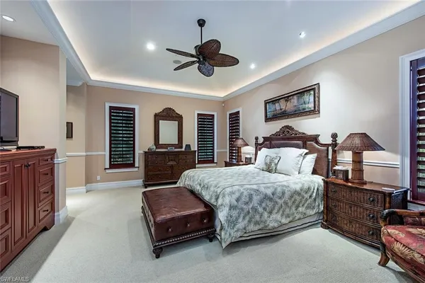 a living room with a bed furniture and a flat tv screen