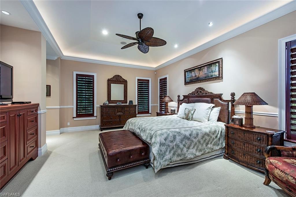 85 13th Avenue South Naples, FL 34102 - Photo 7 of 13 a living room with a bed furniture and a flat tv screen