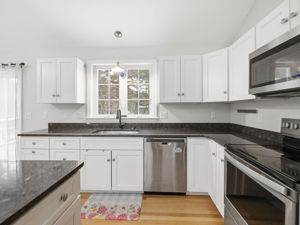 661 Wheelwright Road Barre, MA 01005 - Photo 13 of 42 a kitchen with granite countertop a sink and a stove top oven