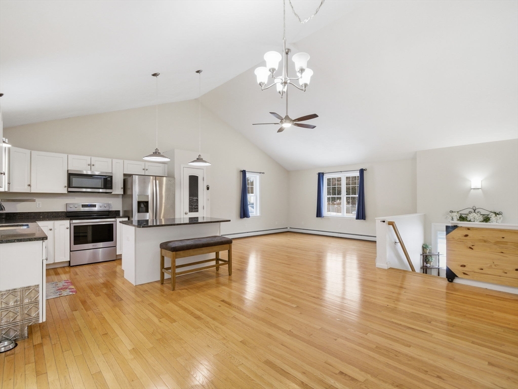 661 Wheelwright Road Barre, MA 01005 - Photo 16 of 42 a view of a living room and kitchen with furniture wooden floor