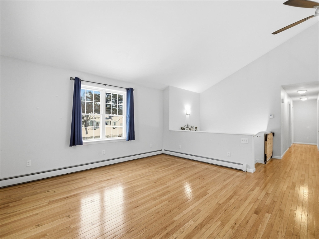 661 Wheelwright Road Barre, MA 01005 - Photo 17 of 42 an empty room with wooden floor and windows