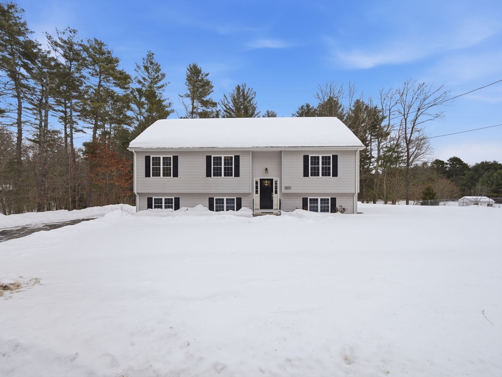 661 Wheelwright Road Barre, MA 01005 - Photo 2 of 42 a front view of a house with a yard covered with snow