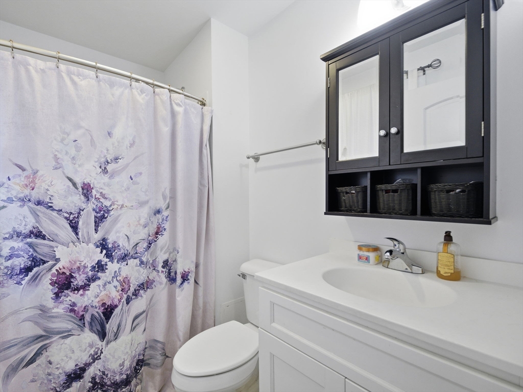 661 Wheelwright Road Barre, MA 01005 - Photo 29 of 42 a bathroom with a granite countertop sink mirror vanity and toilet