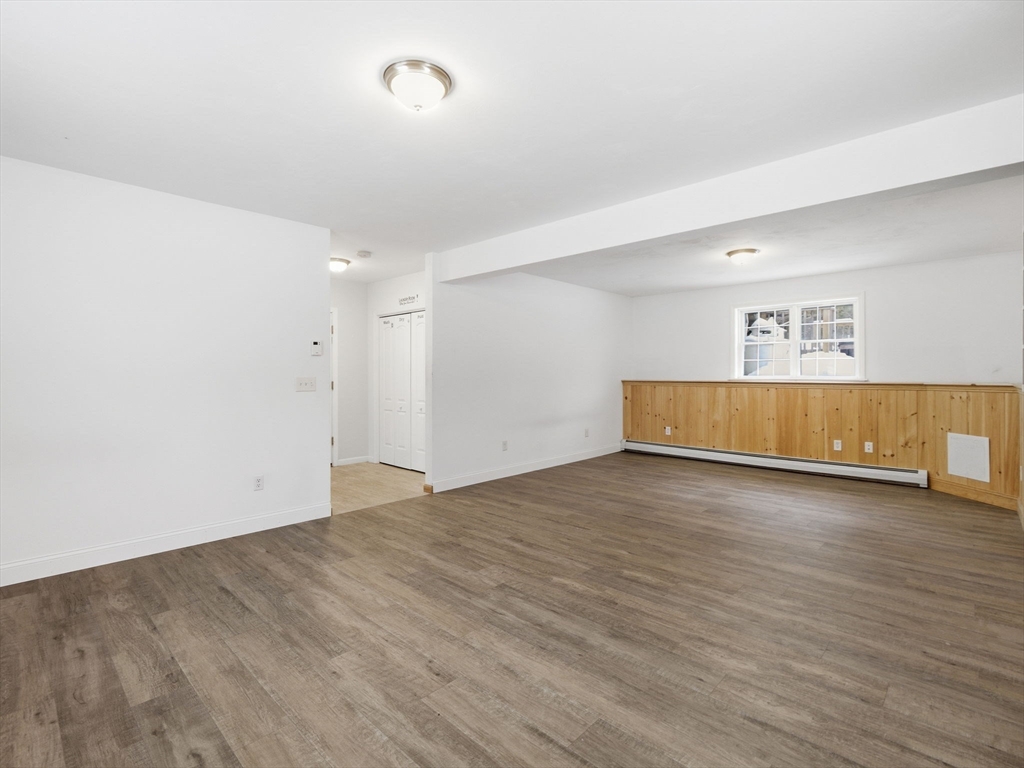 661 Wheelwright Road Barre, MA 01005 - Photo 33 of 42 an empty room with wooden floor and windows