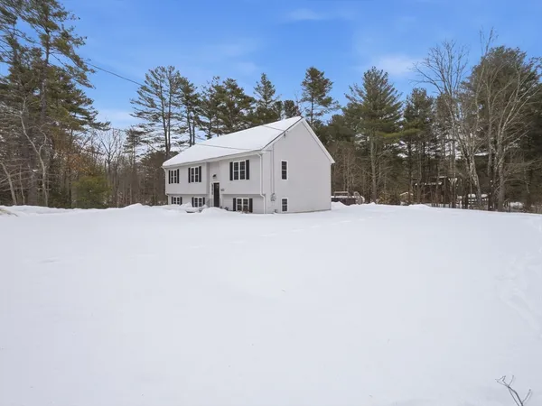 a view of house with a yard covered in snow