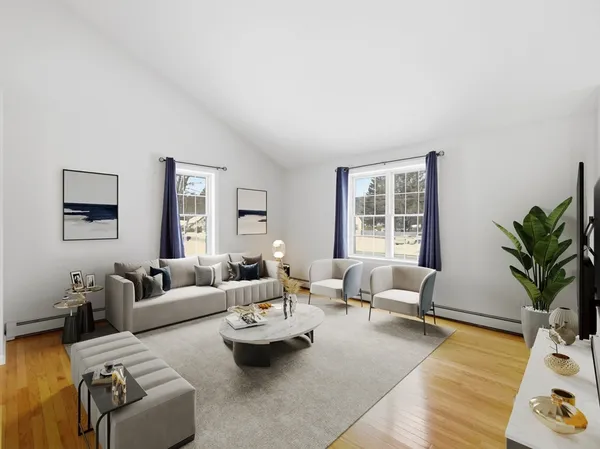 a living room with furniture and a potted plant