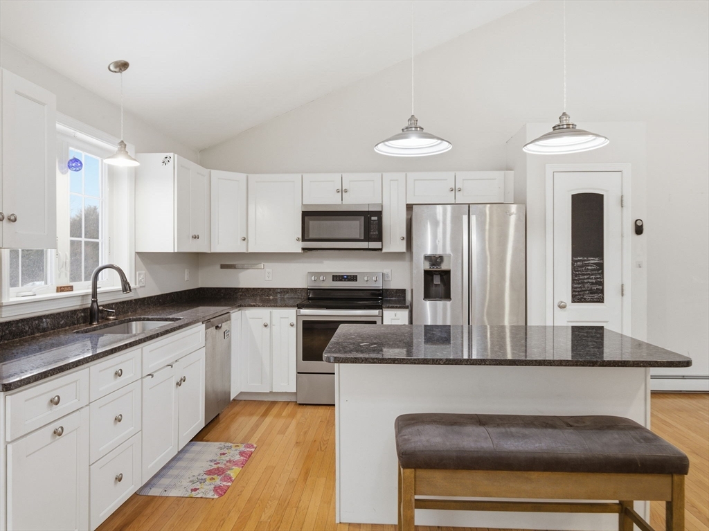 661 Wheelwright Road Barre, MA 01005 - Photo 10 of 42 a kitchen with stainless steel appliances granite countertop a stove a sink and a refrigerator