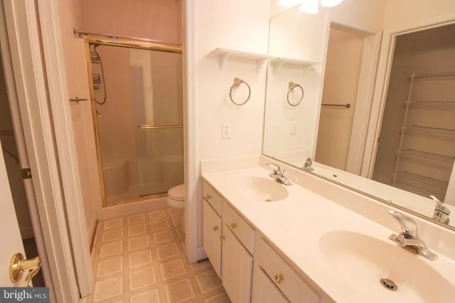 a bathroom with a granite countertop shower and a toilet