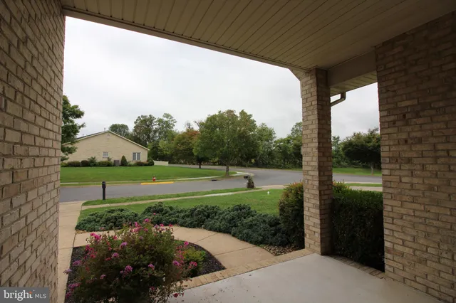 a front view of a house with outdoor seating