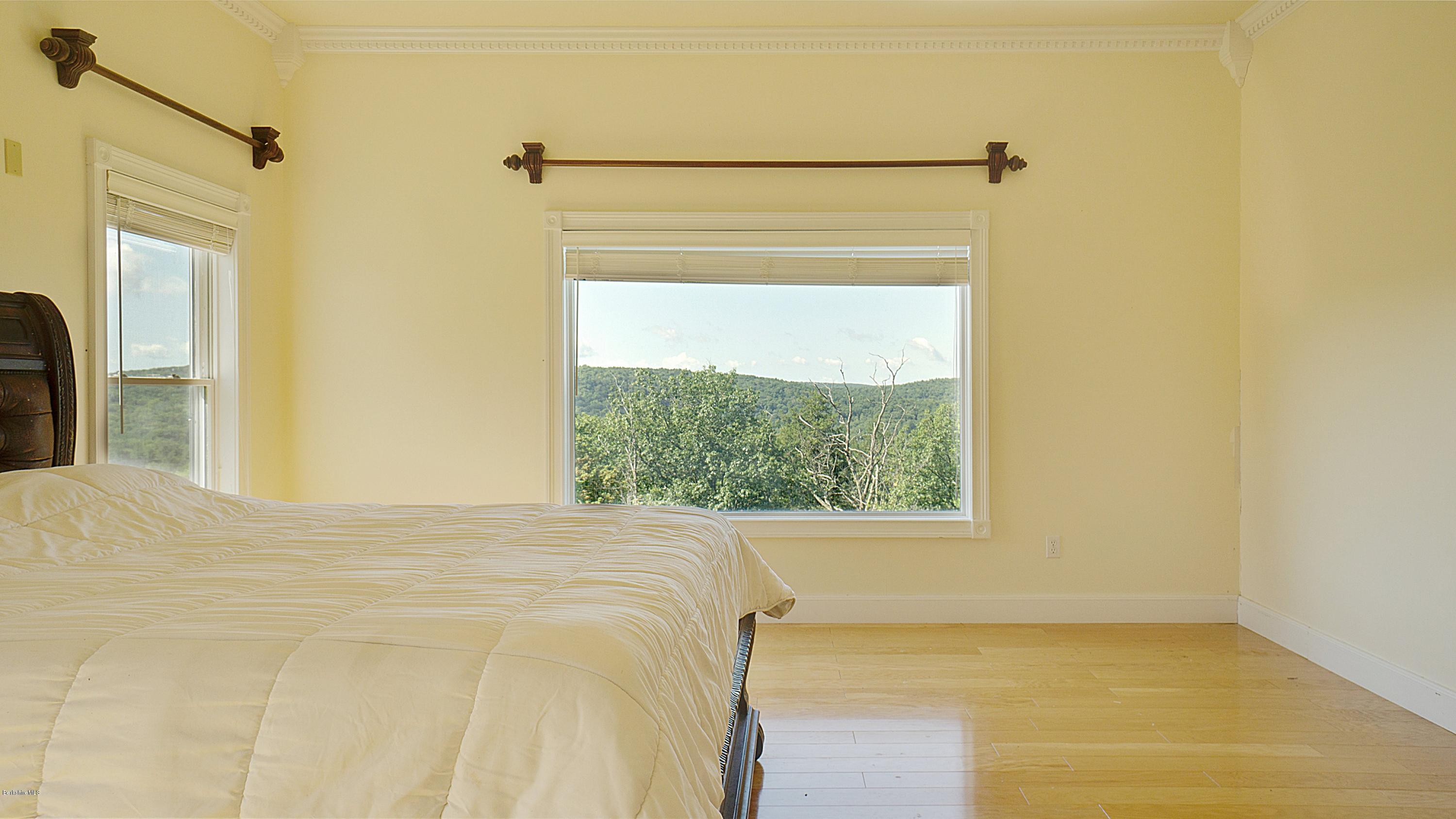 79 Hupi Road Monterey, MA 01245 - Photo 14 of 33 a bedroom with a bed and a window