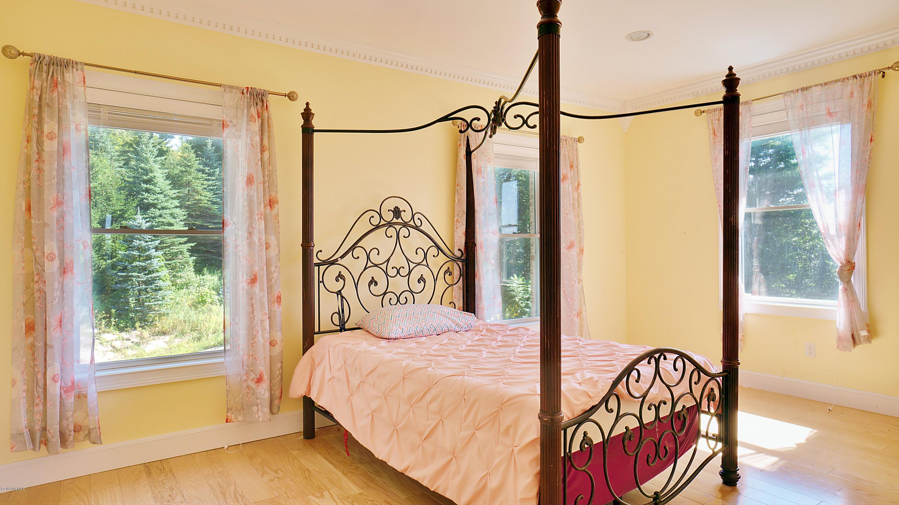 79 Hupi Road Monterey, MA 01245 - Photo 18 of 33 a bedroom with a bed and a window