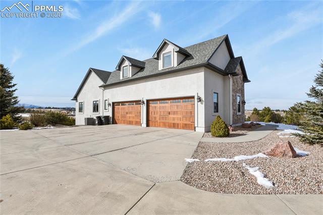 5220 Roundup Ridge Road Colorado Springs, CO 80908 - Photo 42 of 50 New insulated carriage style garage doors, all concrete approach and driveway