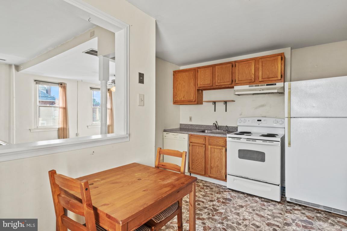 201 North Line Street Lansdale, PA 19446 - Photo 13 of 24 a kitchen with stainless steel appliances granite countertop a stove a sink dishwasher and a refrigerator with wooden cabinets