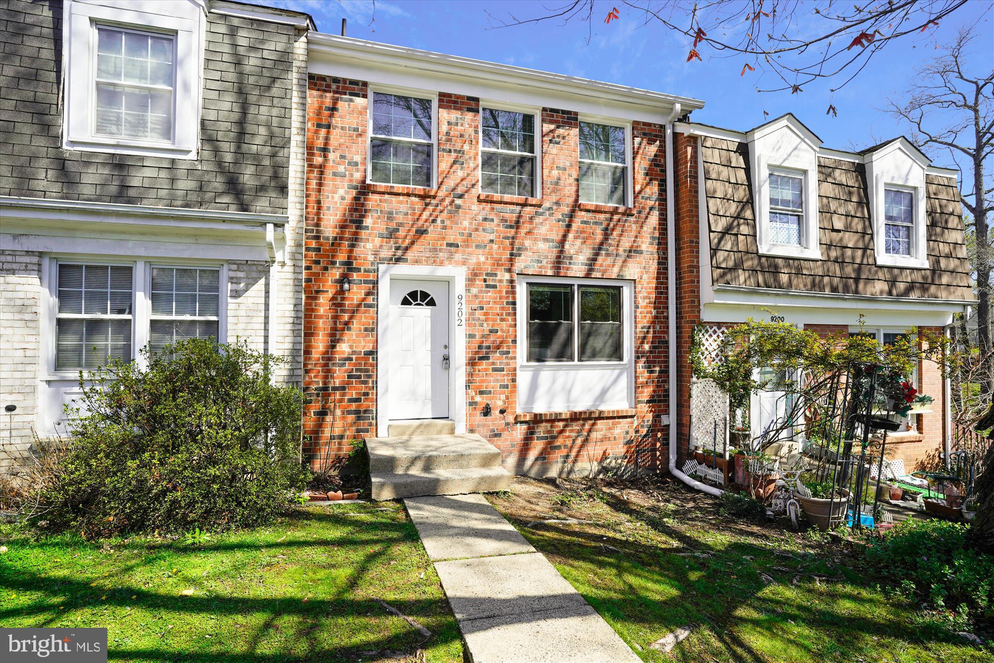 9202 Sprucewood Road Burke, VA 22015 - Photo 3 of 21 a front view of a house with a yard