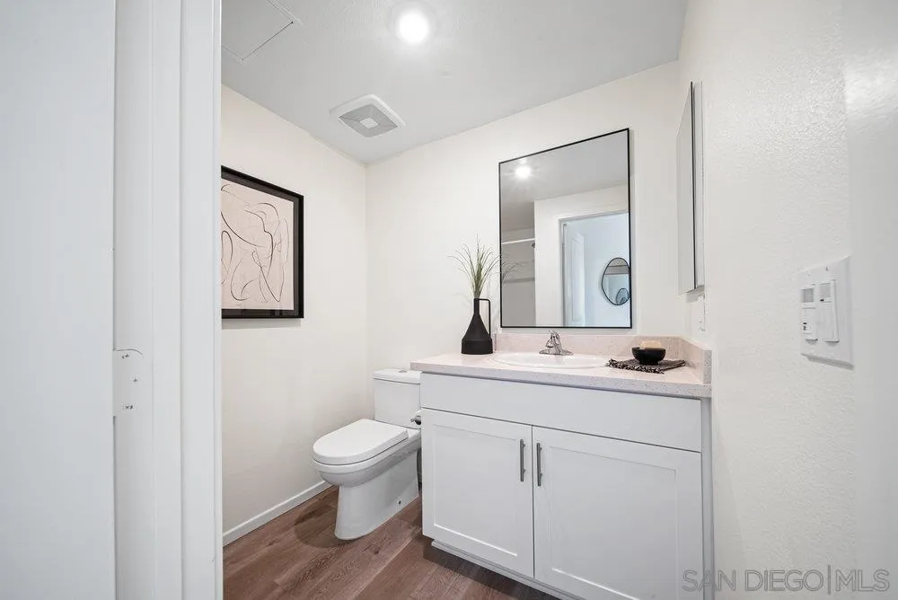 8154 Golden Avenue Lemon Grove, CA 91945 - Photo 17 of 50 a bathroom with a toilet a sink and mirror