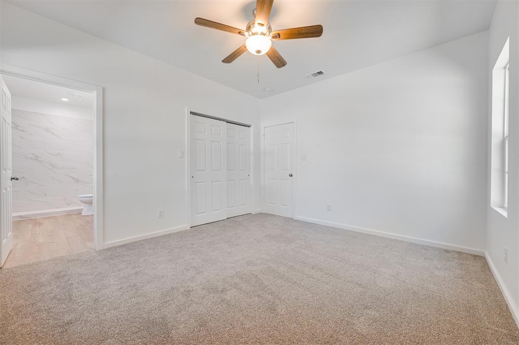 540 Southeast 2nd Street Cooper, TX 75432 - Photo 20 of 30 an empty room with a ceiling fan and a window