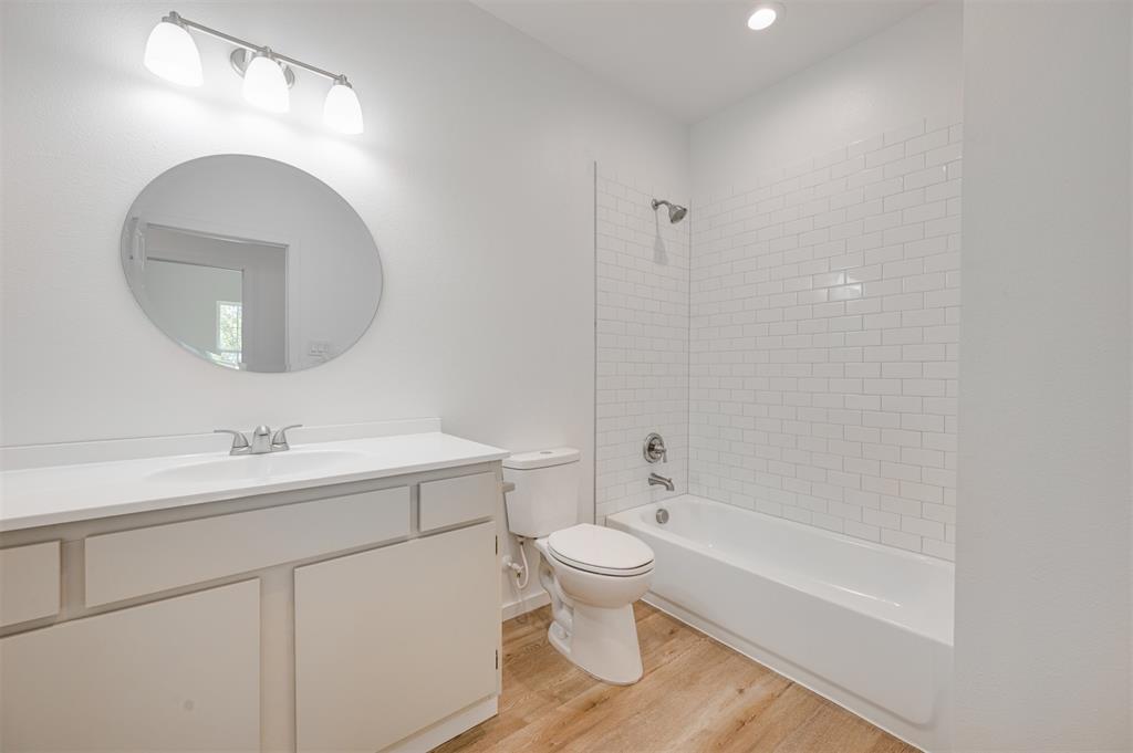 540 Southeast 2nd Street Cooper, TX 75432 - Photo 24 of 30 a bathroom with a sink a toilet and a mirror