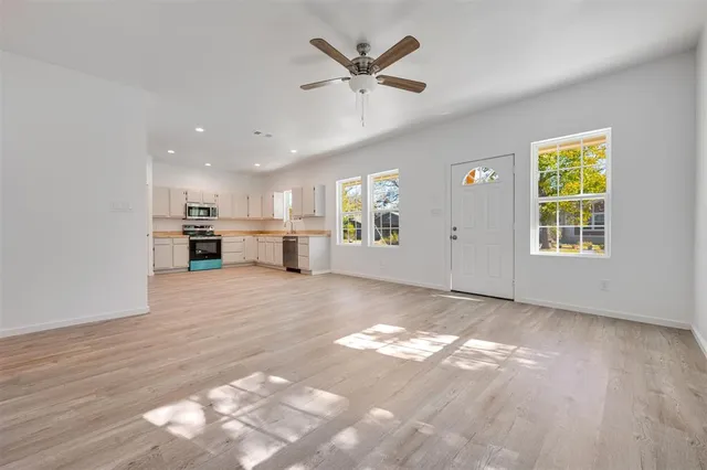 a view of a livingroom with a kitchen and a stove top oven