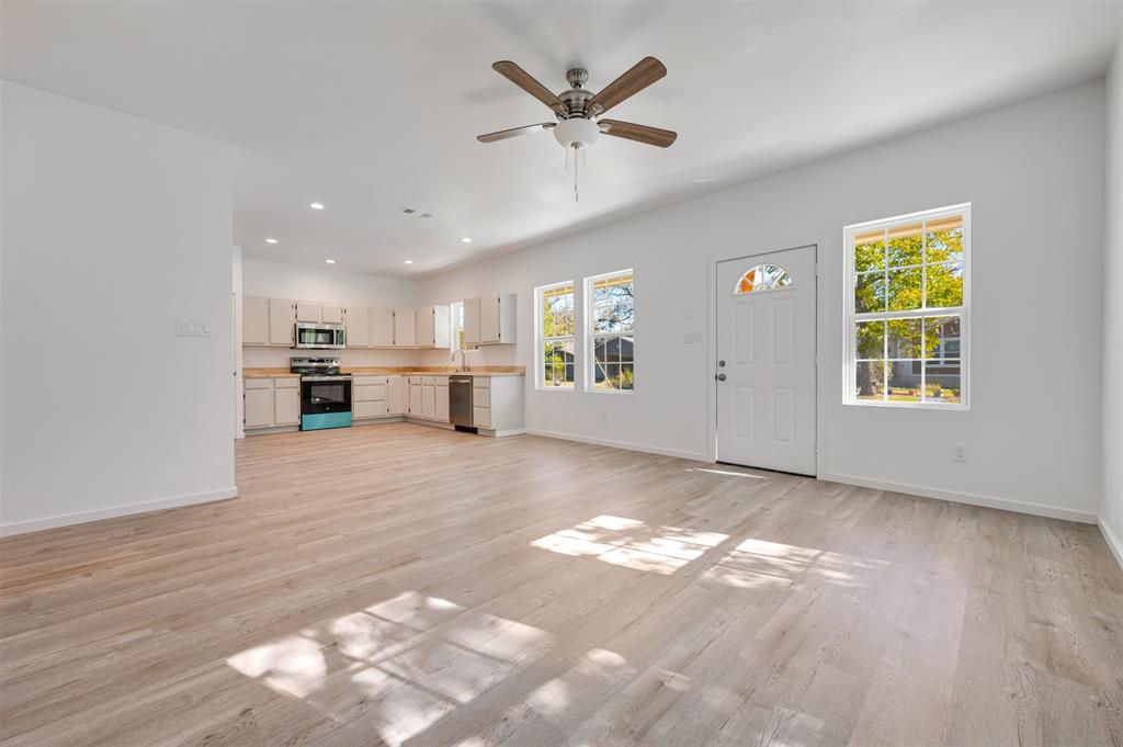 540 Southeast 2nd Street Cooper, TX 75432 - Photo 8 of 30 a view of a livingroom with a kitchen and a stove top oven