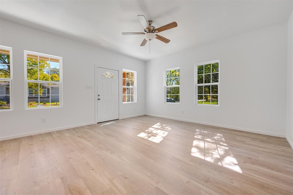 540 Southeast 2nd Street Cooper, TX 75432 - Photo 9 of 30 a view of an empty room with a window and wooden floor