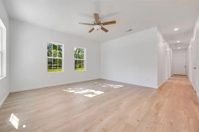 a view of a livingroom with a ceiling fan and window