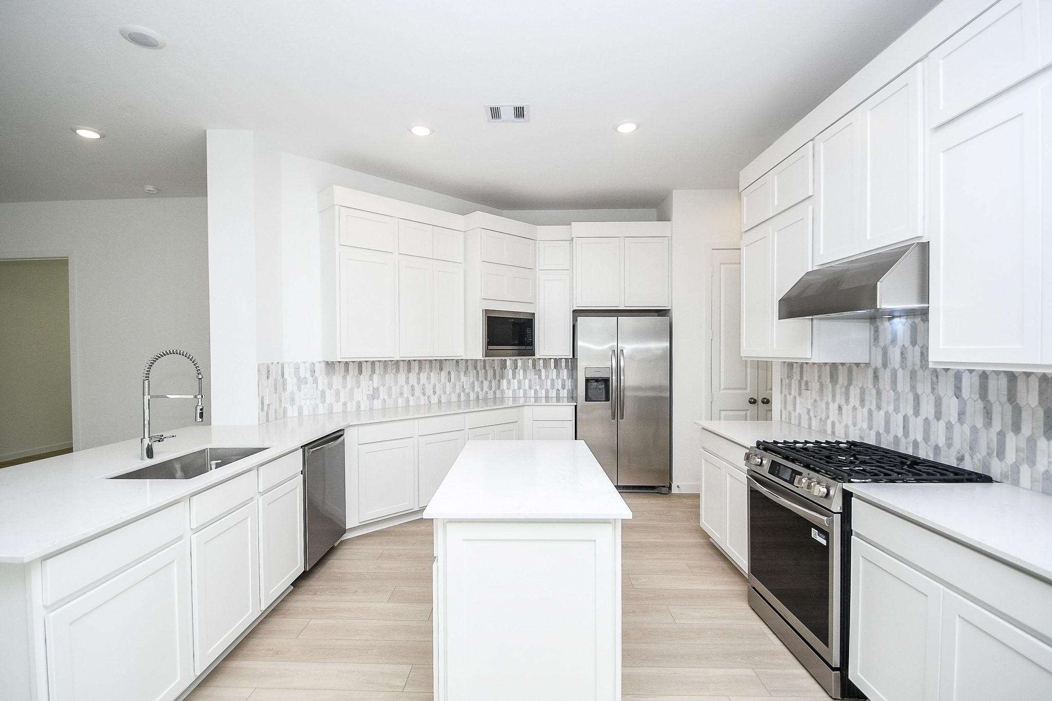 4227 Eagle Pass Drive Rosenberg, TX 77469 - Photo 4 of 28 a large kitchen with a large counter top stainless steel appliances and cabinets